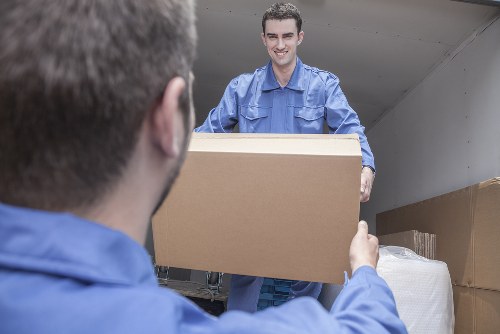 Removal van and moving team in a New Southgate residential street