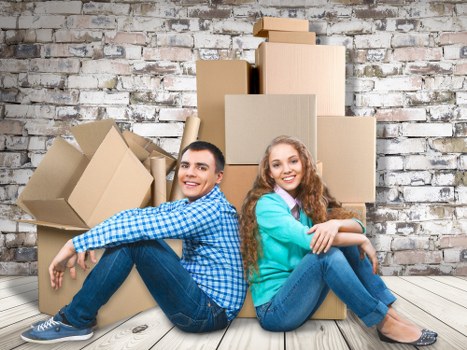 Packed moving boxes and furniture ready for transport in New Southgate