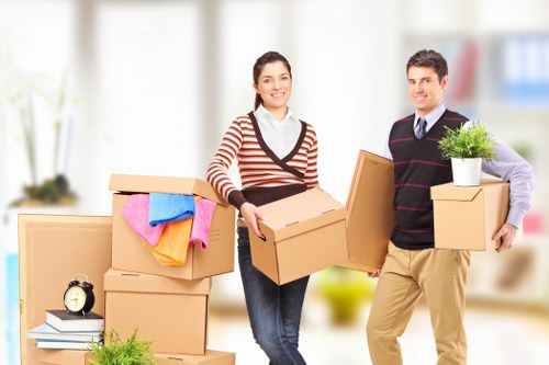 Safety-focused moving staff handling a bulky item carefully